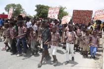 El Roi Academy students march down on the street after a press conference to demand the freedom ...