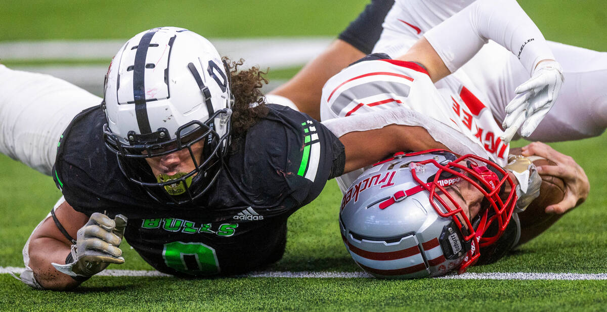 SLAM Academy DE Andre Cade (0) drags down Truckee QB Julian Hall (14) to the turf for a sack du ...