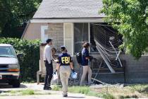 Law enforcement investigate the scene of a shooting involving the FBI Wednesday, Aug. 9, 2023 i ...