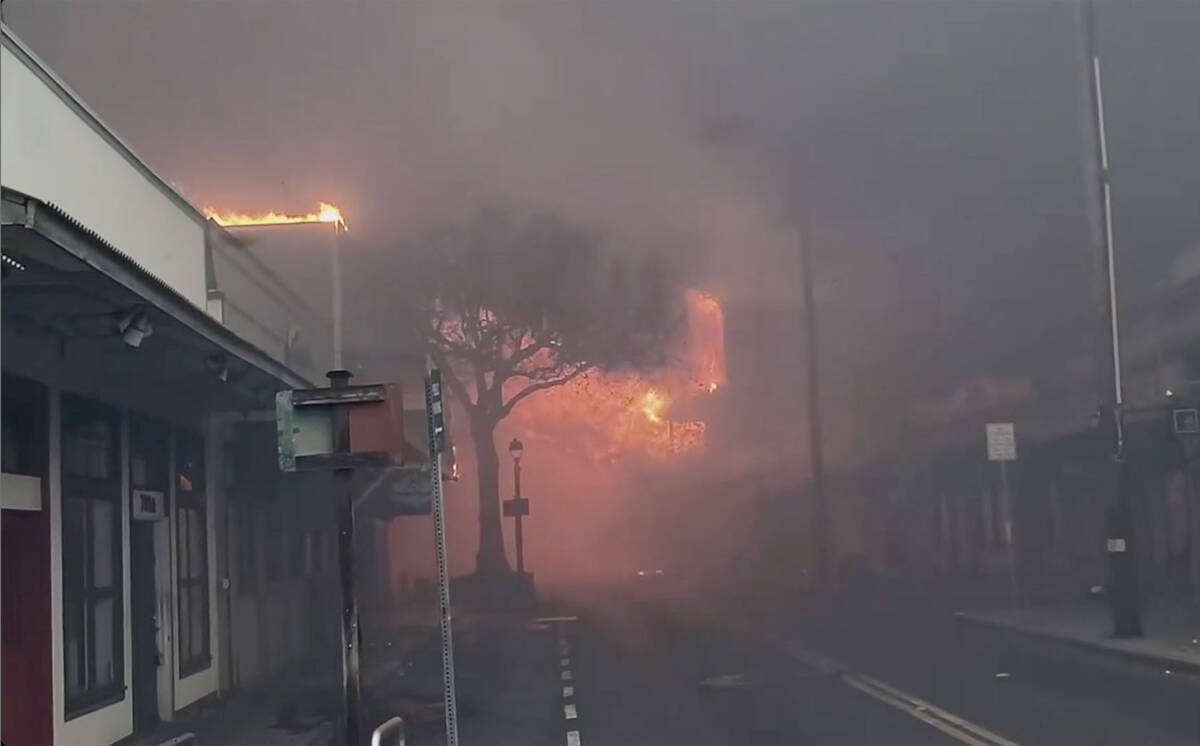 Smoke and flames fill the air from raging wildfires on Front Street in downtown Lahaina, Maui o ...