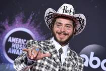 Post Malone arrives at the American Music Awards at the Microsoft Theater in Los Angeles on Nov ...