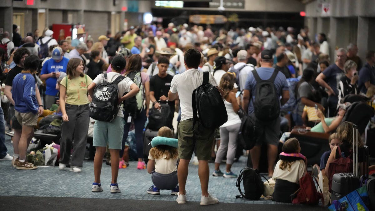 People gather at the Kahului Airport while waiting for flights Wednesday, Aug. 9, 2023, in Kahu ...