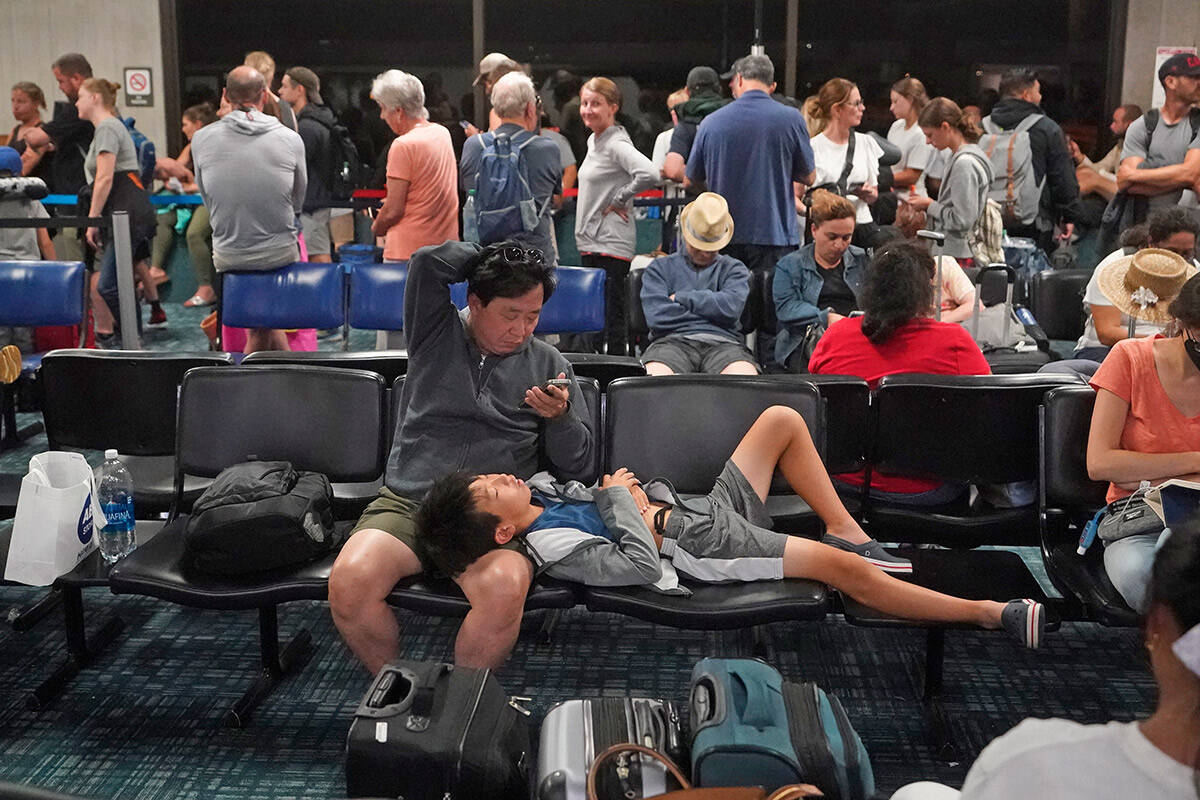 People gather at the Kahului Airport while waiting for flights Wednesday, Aug. 9, 2023, in Kahu ...