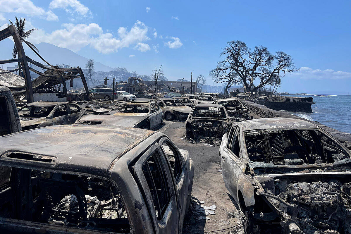 In this photo provided by Tiffany Kidder Winn, burned-out cars sit after a wildfire raged throu ...