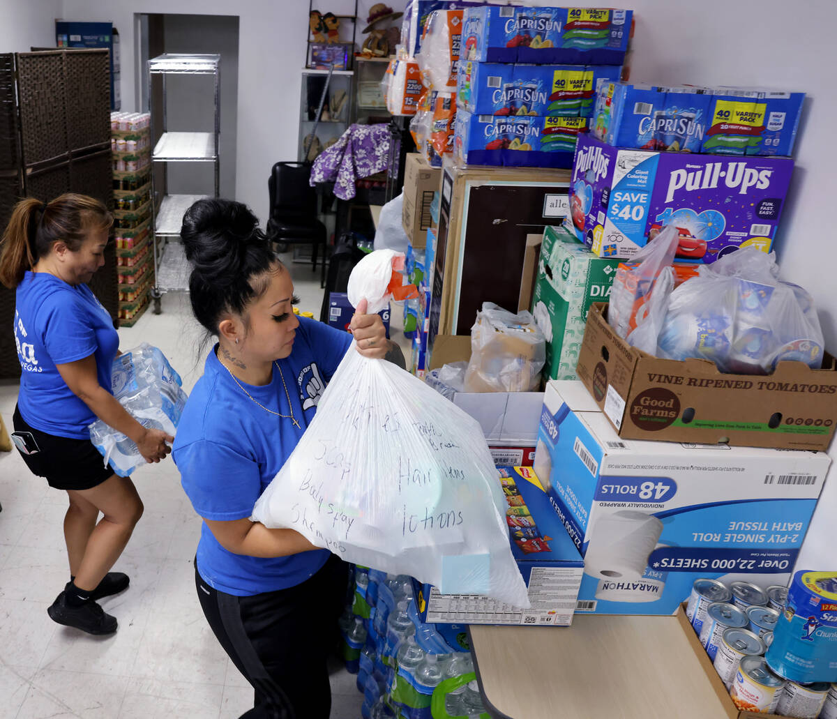 Shanice Walter, right, and her mother Shai Walter organize donations for victims of the Maui fi ...