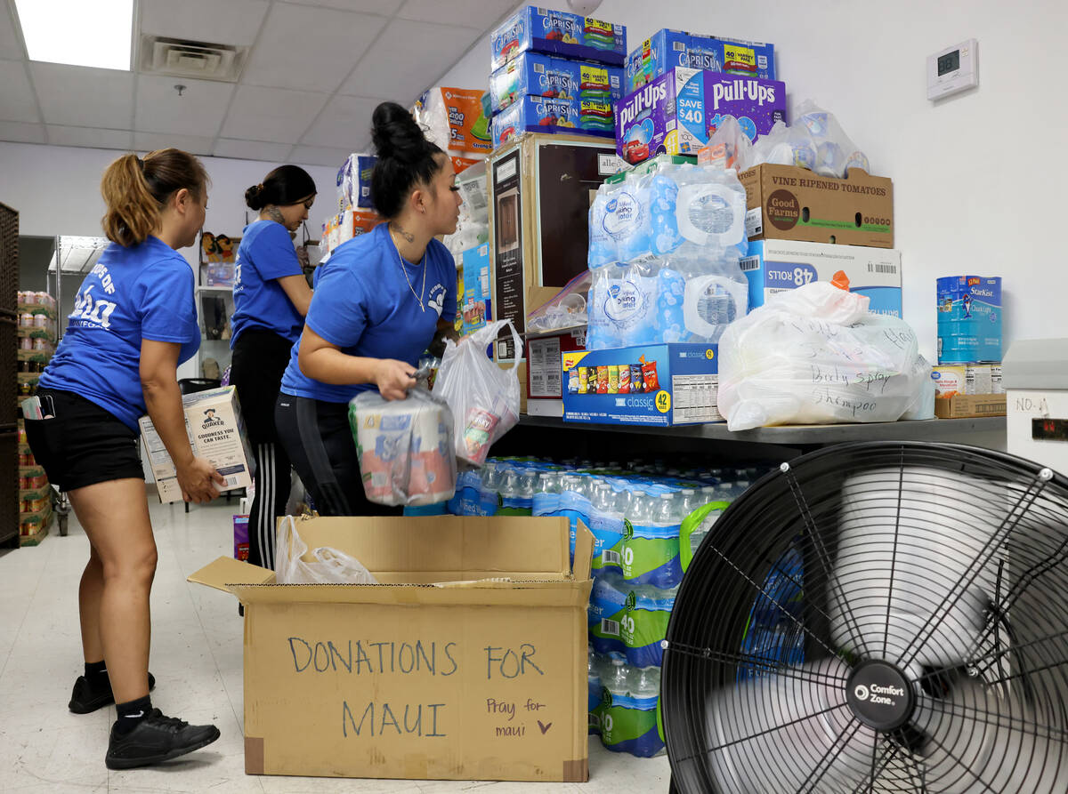 Shai Walter, from left, daughter-in-law Alijah Walter and daughter Shanice Walter organize dona ...