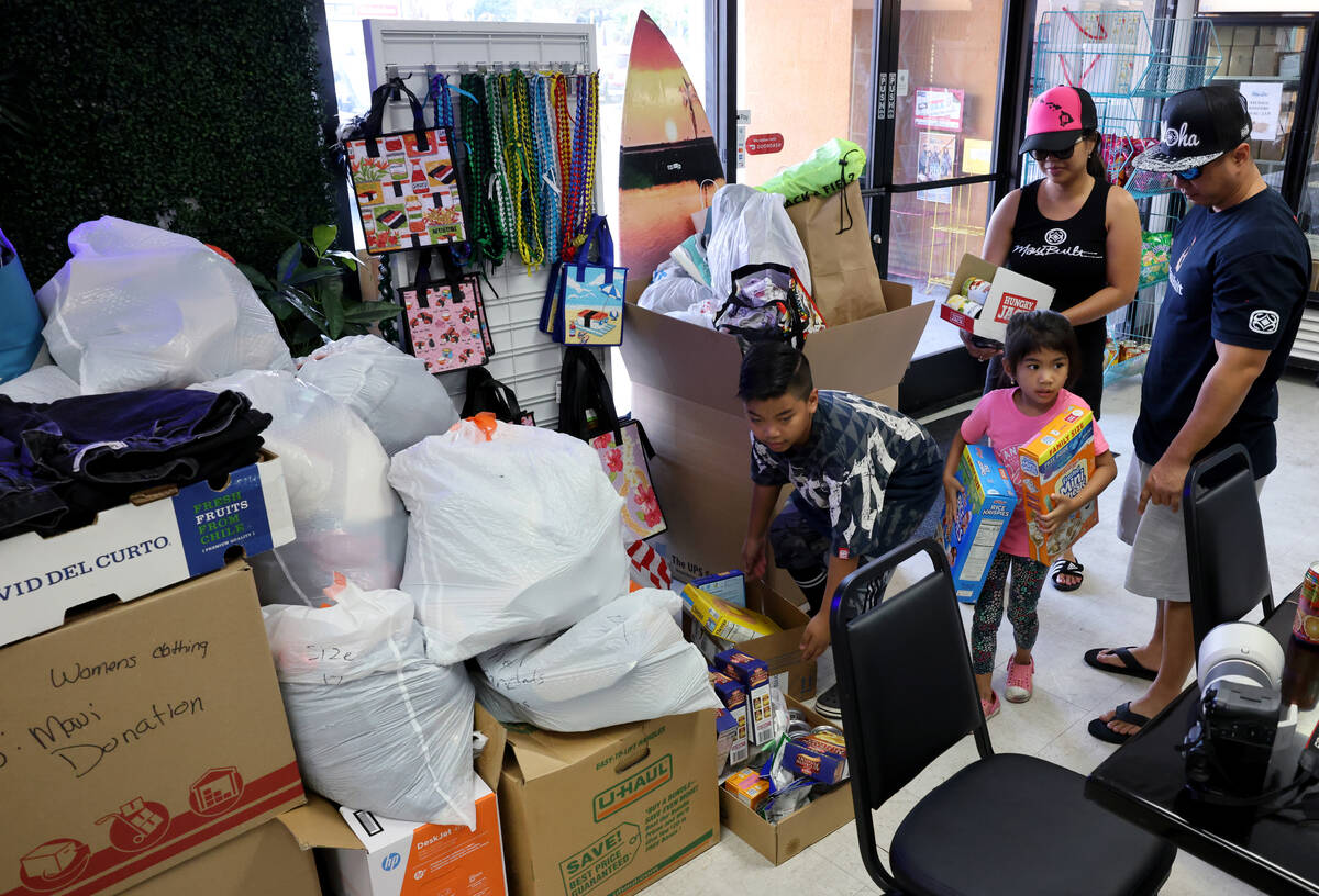 Jeden and Jeff Medina, originally of Maui, drop off donations with their children Jedson, 9, Jh ...