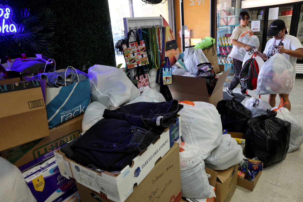 Jewelyn Garcia, right, and Maria Cabrera of Las Vegas drop off donations for victims of the Mau ...