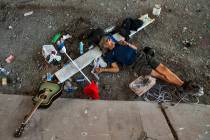 A homeless individual takes a nap below the Flamingo Road overpass in May 2019 in Las Vegas. (L ...