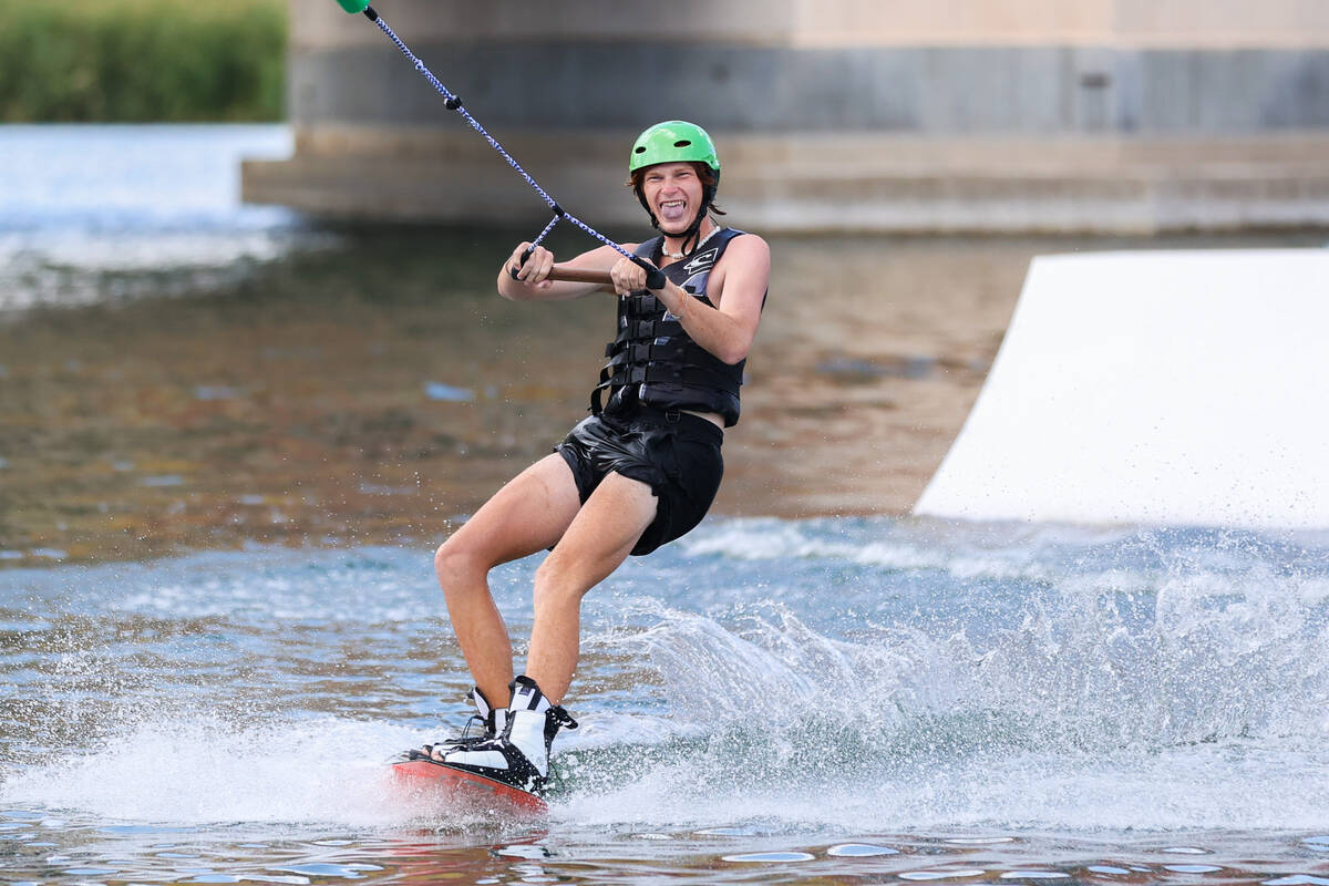 Ian Dross smiles as he rides a wakeboard which he rented out through Lake Las Vegas Water Sport ...