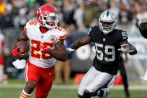 Kansas City Chiefs running back Damien Williams (26) runs in front of Oakland Raiders linebacke ...