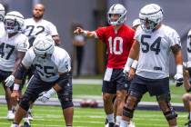Raiders quarterback Jimmy Garoppolo (10) calls a play at the offensive line with teammates duri ...