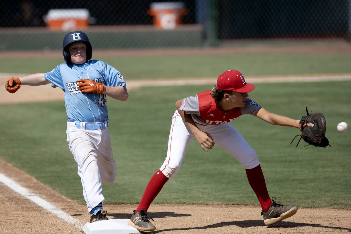 Henderson extra hitter Chase Daley (45) makes it safely to first base while Utah pitcher Brogan ...