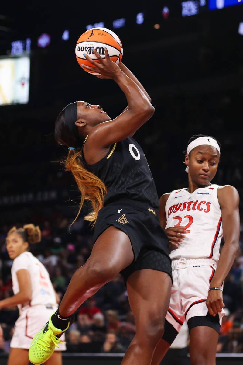 Las Vegas Aces guard Jackie Young (0) shoots a layup over Washington Mystics guard Shatori Walk ...