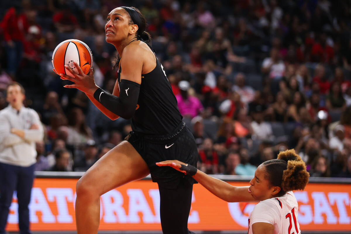 Las Vegas Aces forward A'ja Wilson (22) moves past Washington Mystics forward Tianna Hawkins (2 ...