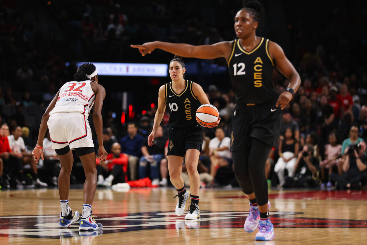 Las Vegas Aces guard Chelsea Gray (12) points to a player as Las Vegas Aces guard Kelsey Plum ( ...