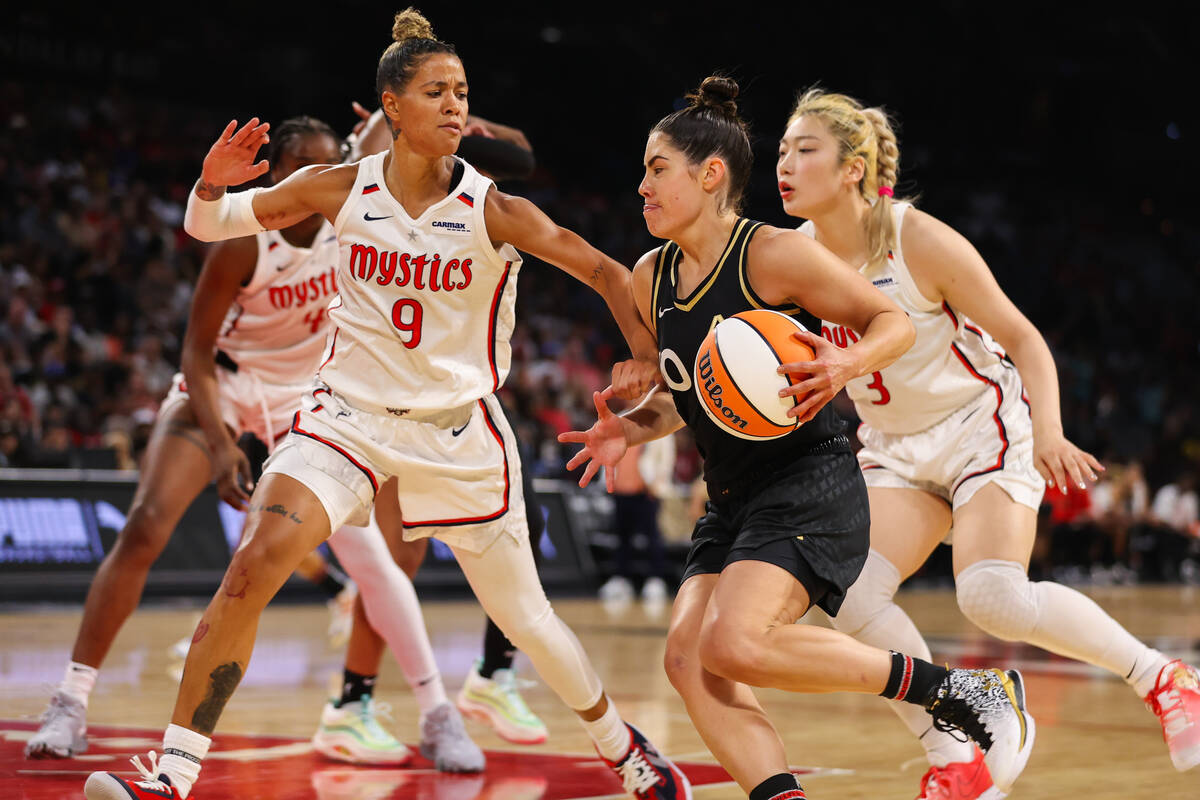 Las Vegas Aces guard Kelsey Plum (10) drives to the basket past Washington Mystics guard Natash ...