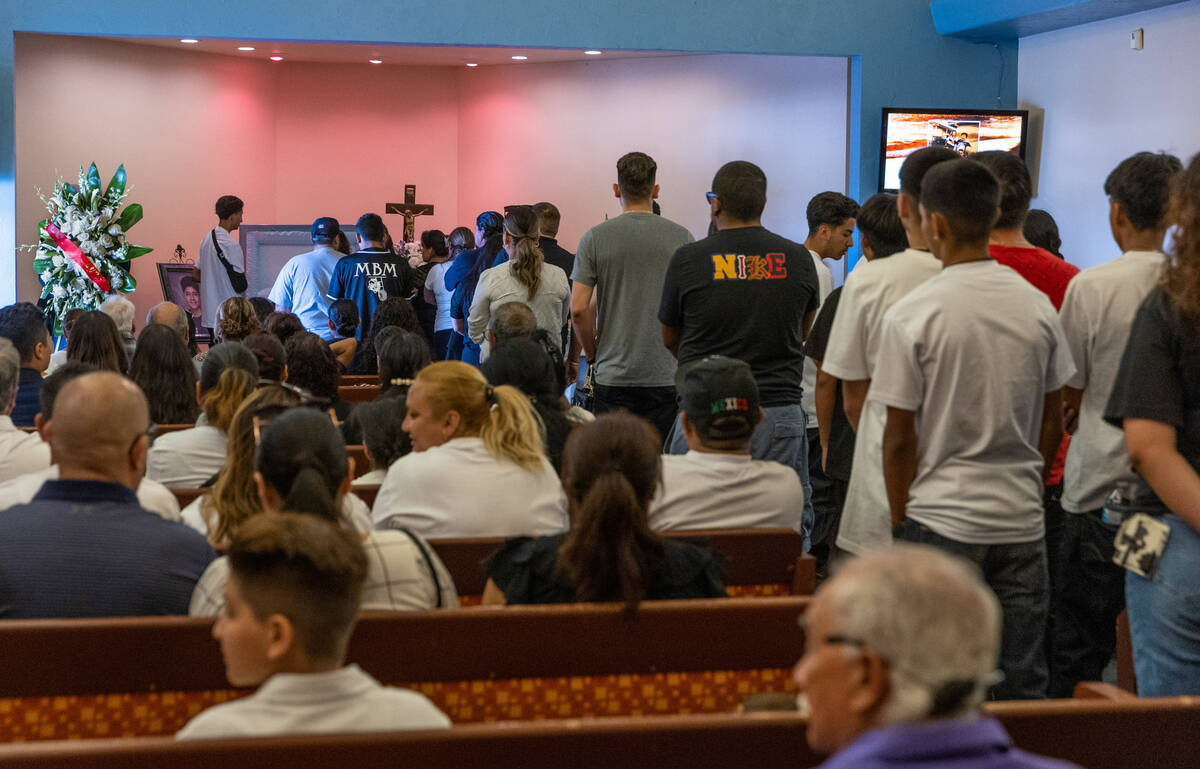 Mourners line up to say their final goodbyes during funeral services for Angel Naranjo at Palm ...