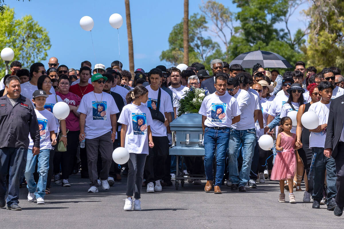 Rudolfo Naranjo, center, he, his son Arley and others wheel the casket of his son Angel from th ...