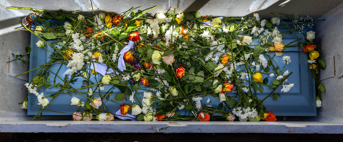 Angel Naranjo's casket is covered with flowers and white gloves following funeral services for ...