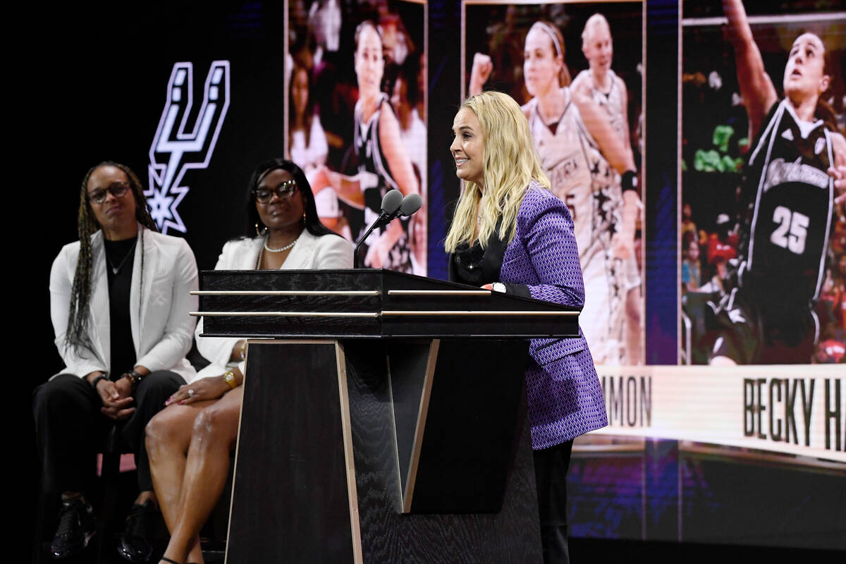 Becky Hammon speaks during her enshrinement at the Basketball Hall of Fame as presenters Teresa ...