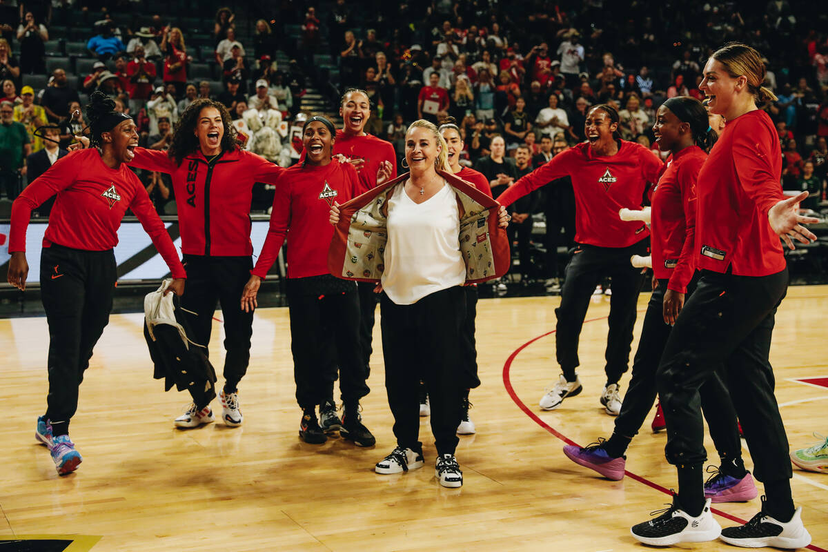 Aces head basketball coach Becky Hammon, center, shows off her Naismith Basketball Hall of Fam ...