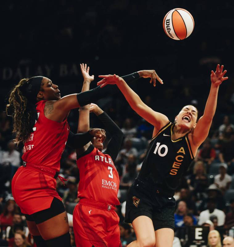 Aces guard Kelsey Plum (10) fights for the ball as she loses her grip of it during a game again ...