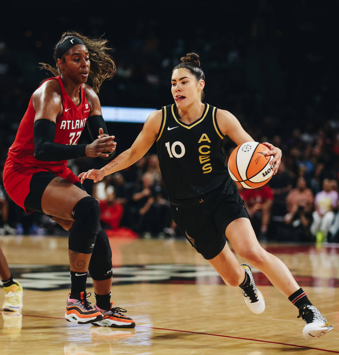 Aces guard Kelsey Plum (10) drives the ball towards the hoop as Atlanta Dream forward Cheyenne ...