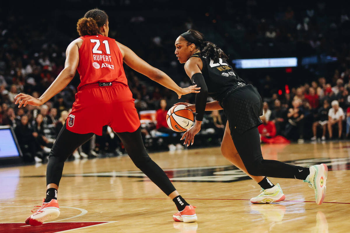 Aces center A’ja Wilson (22) dribbles the ball as Atlanta Dream center Iliana Ruper (21) ...