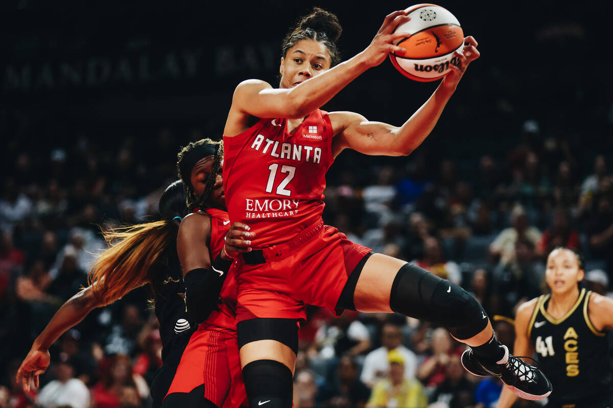 Atlanta Dream forward Nia Coffey (12) grabs the ball before the Aces can rebound with it during ...