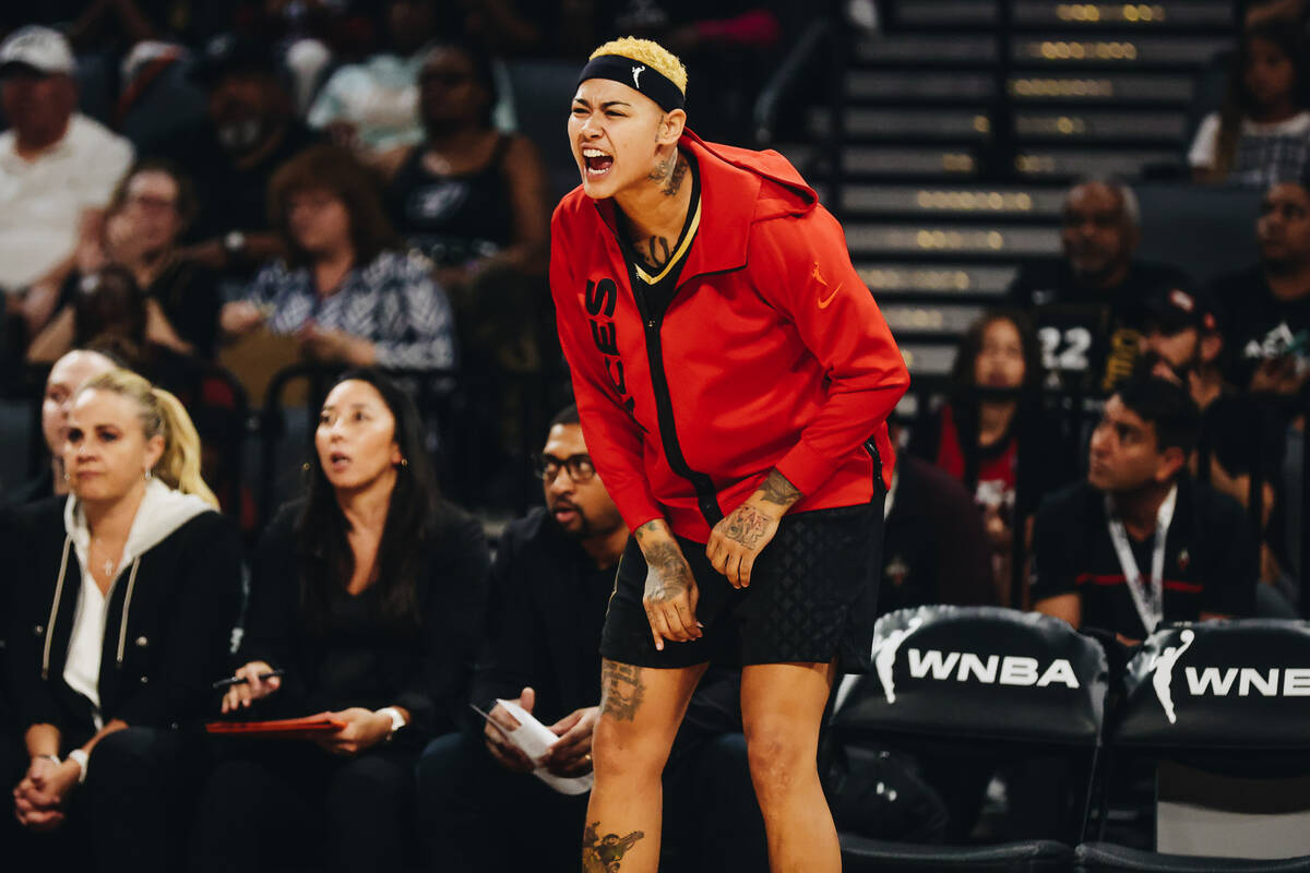 Aces forward Kierstan Bell yells in support of her teammates from the sidelines during a game a ...