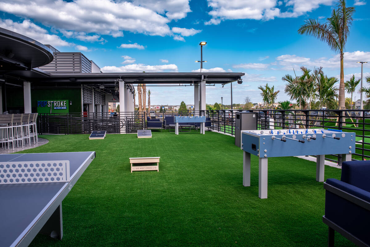 An artist rendering of the beer garden at PopStroke, which features games including cornhole, f ...