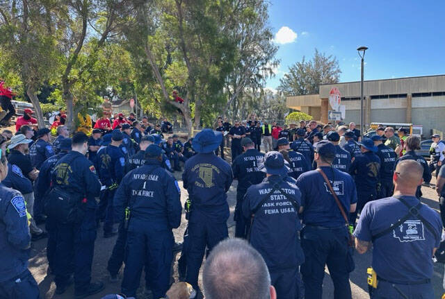 Members of Nevada Task Force-1 and the Washington State Task Force-1 teams muster for their ass ...
