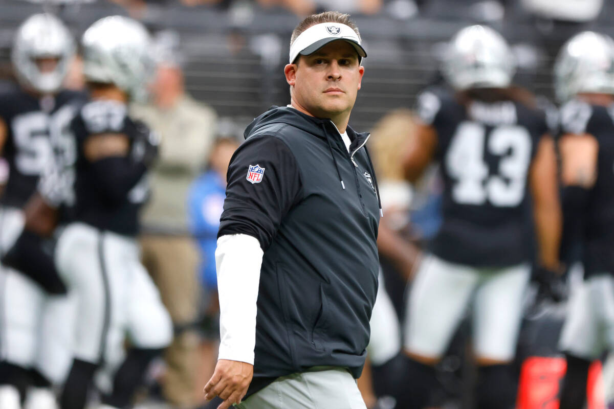 Raiders head coach Josh McDaniels watches his players prior to an NFL preseason football game a ...