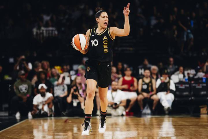 Aces guard Kelsey Plum yells to a teammate while traveling down the court with the ball during ...