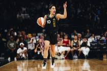 Aces guard Kelsey Plum yells to a teammate while traveling down the court with the ball during ...