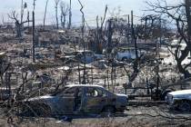 Destroyed homes and cars are shown, Sunday, Aug. 13, 2023, in Lahaina, Hawaii. (AP Photo/Rick B ...
