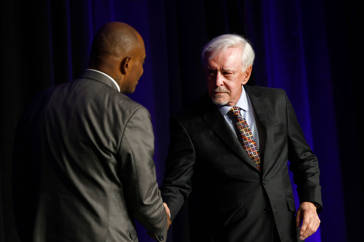 Billy Walters, right, shakes hands with Jon Ponder, founder and CEO of Hope for Prisoners, duri ...