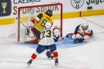 Golden Knights right wing Mark Stone (61) curls a shot around Florida Panthers goaltender Serge ...