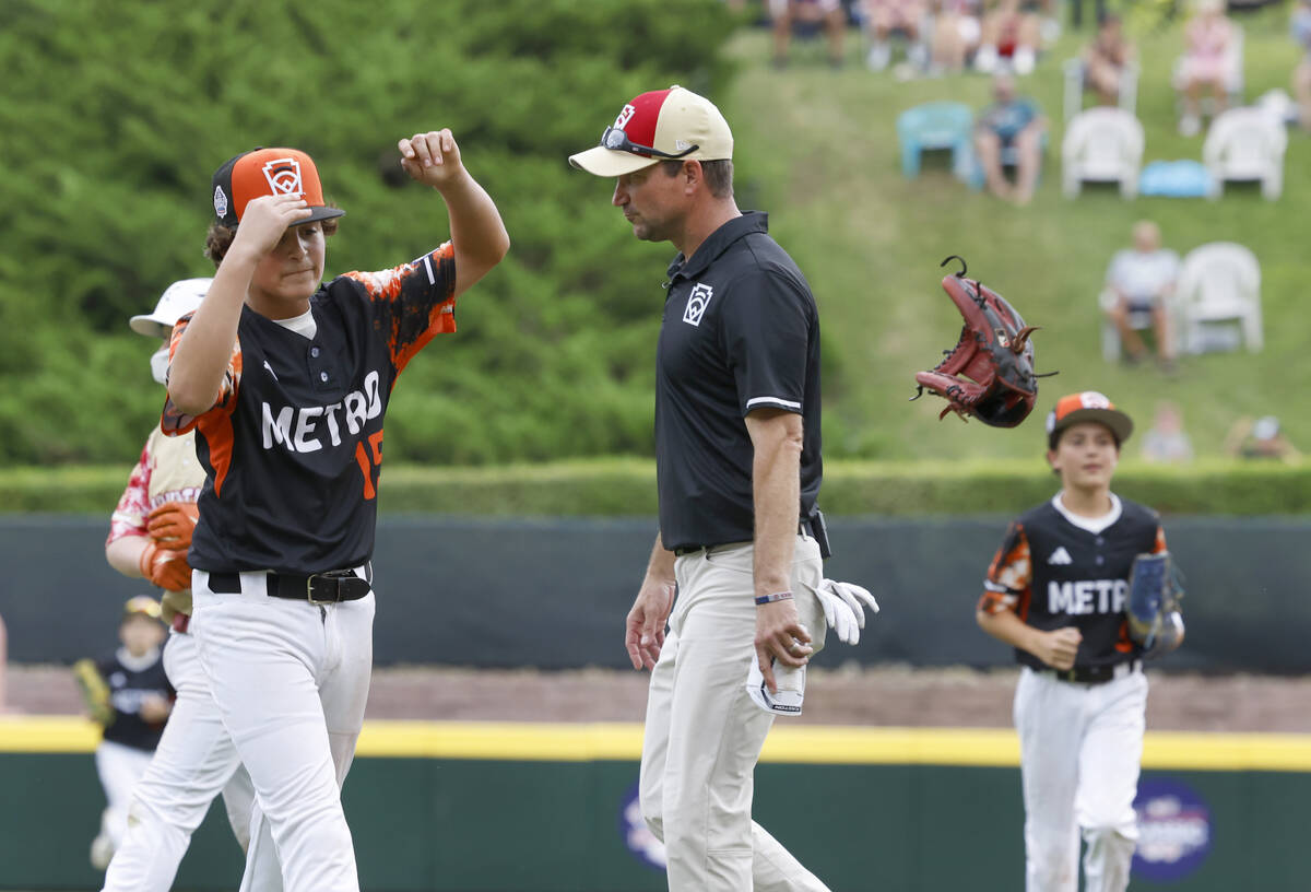 The Henderson All-Stars manager Ryan Gifford, center, leaves the field as Rhode Island pitcher ...