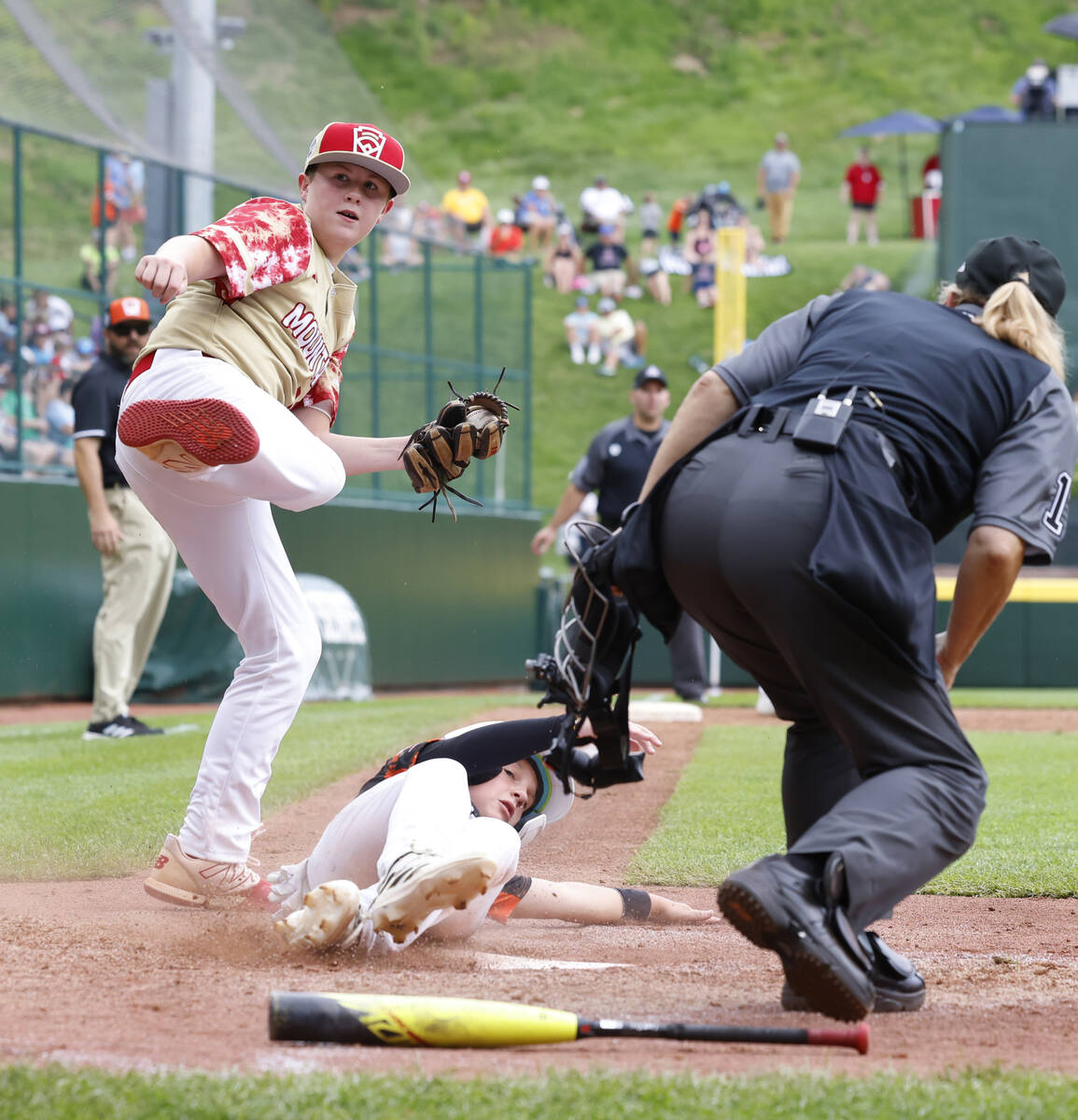 Rhode Island's John Wozniak is tagged out at home by the Henderson All-Stars pitcher Logan Leva ...