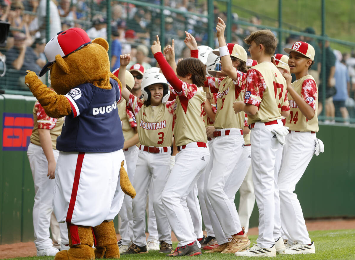 The Henderson All-Stars dance with Dugout, the official mascot of Little League baseball, prior ...