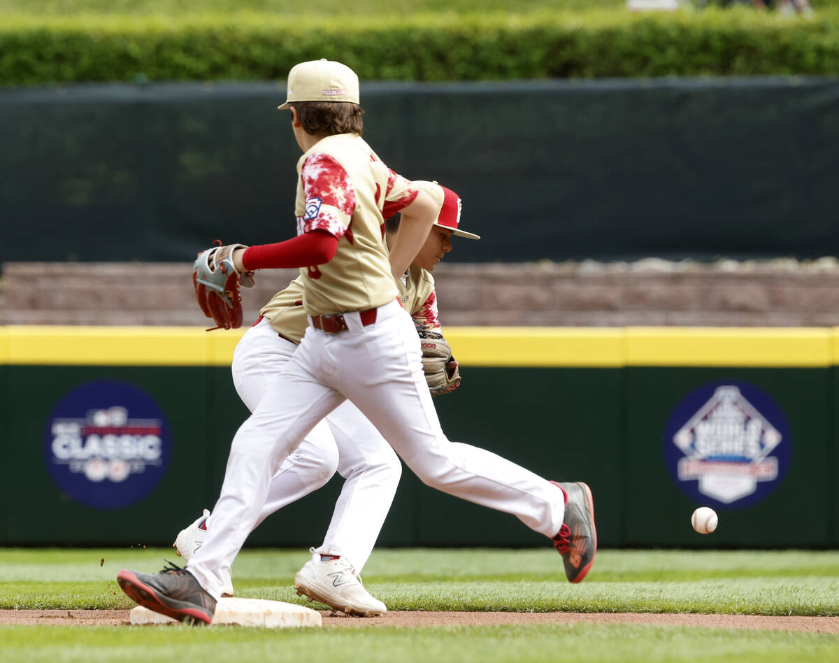 The Henderson All-Stars shortstop David Edwards, left, is unable to stop the ball hit by Rhode ...