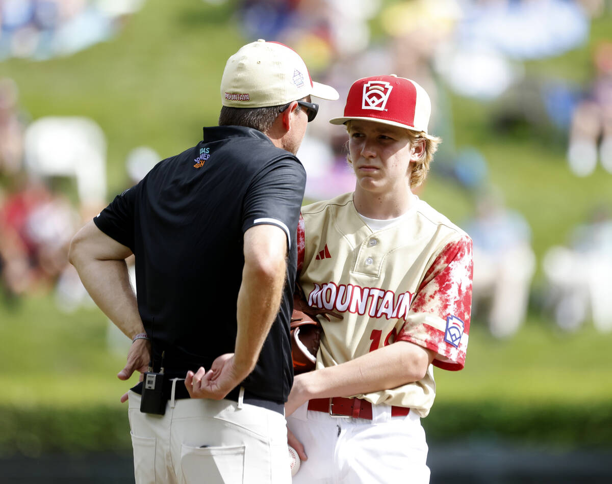The Henderson All-Stars pitcher Nolan Gifford discusses with team manager Ryan Gifford on the m ...