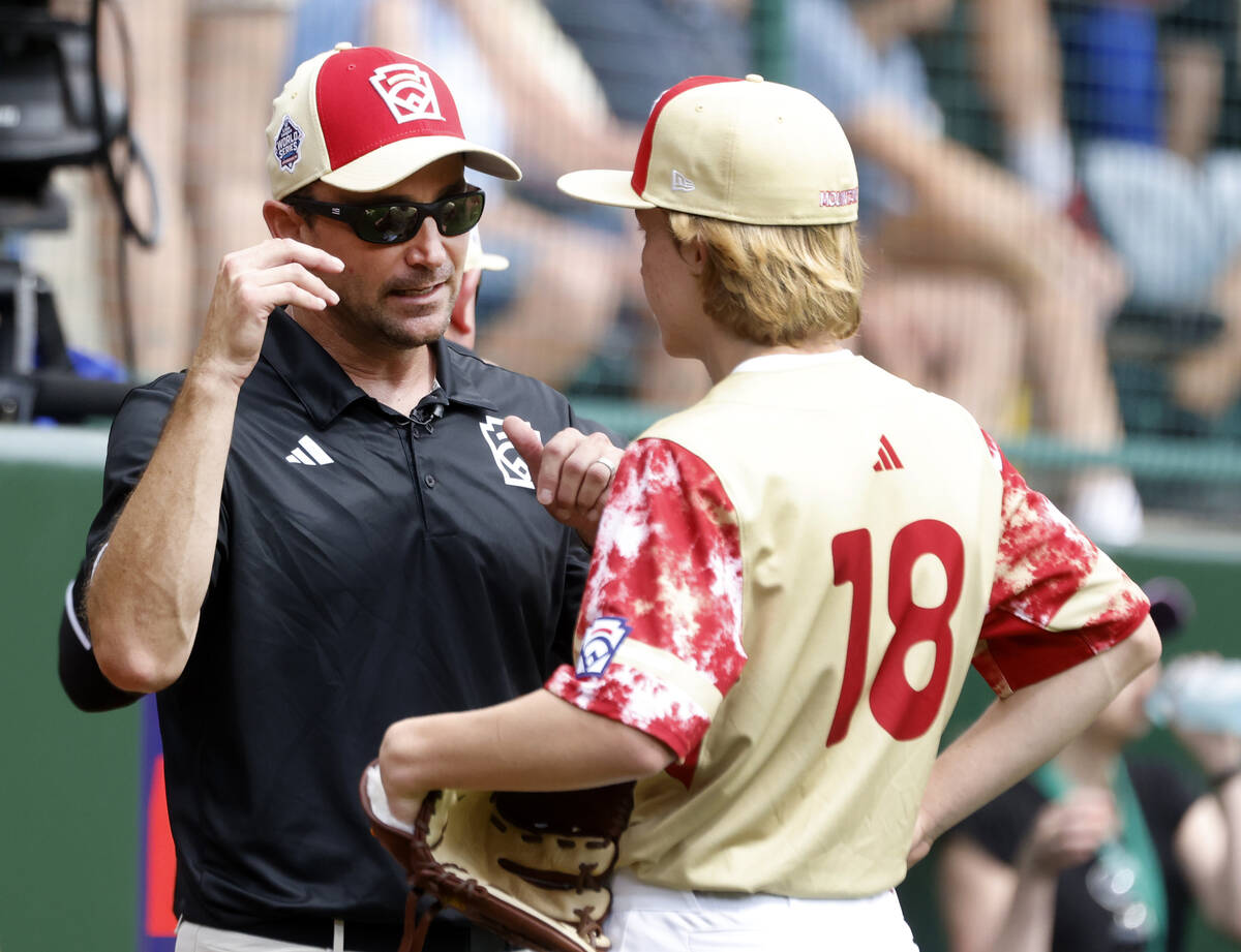 The Henderson All-Stars pitcher Nolan Gifford discusses with team manager Ryan Gifford during t ...
