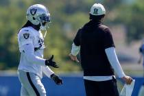 Las Vegas Raiders wide receiver Davante Adams high fives a Raiders coach during a joint NFL foo ...