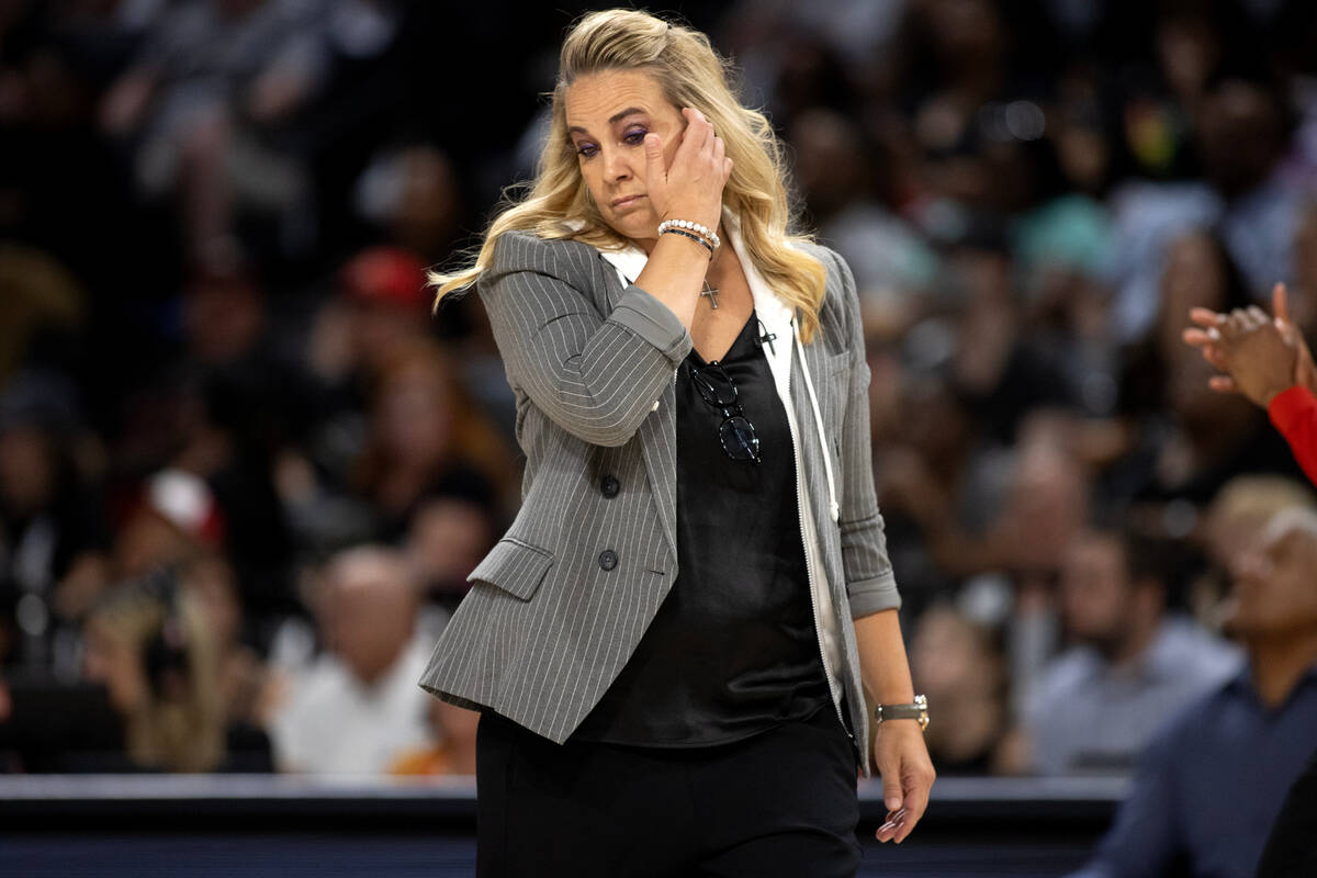 Las Vegas Aces head coach Becky Hammon walks toward the timeout huddle during the first half of ...