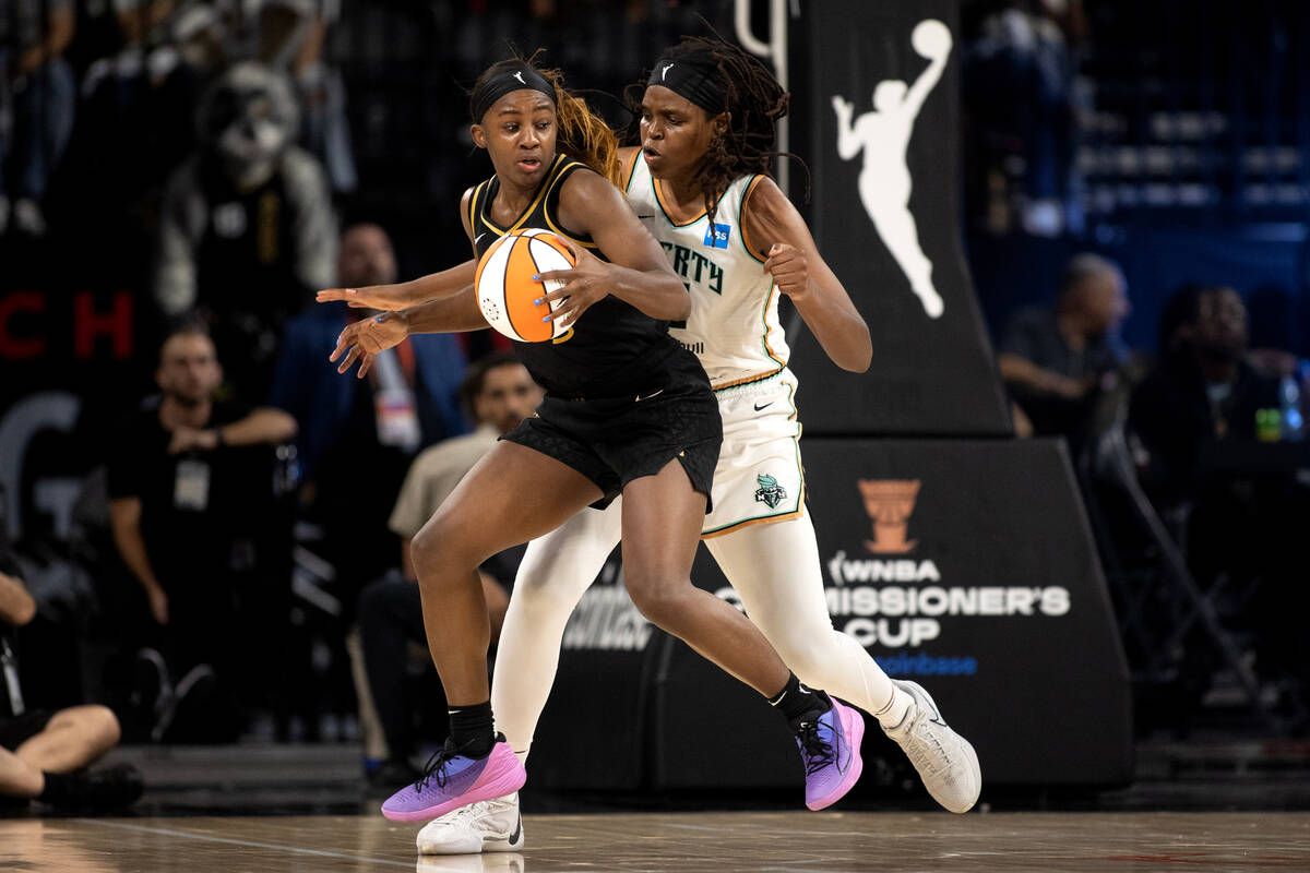 Las Vegas Aces guard Jackie Young (0) works toward the hoop against New York Liberty forward Jo ...