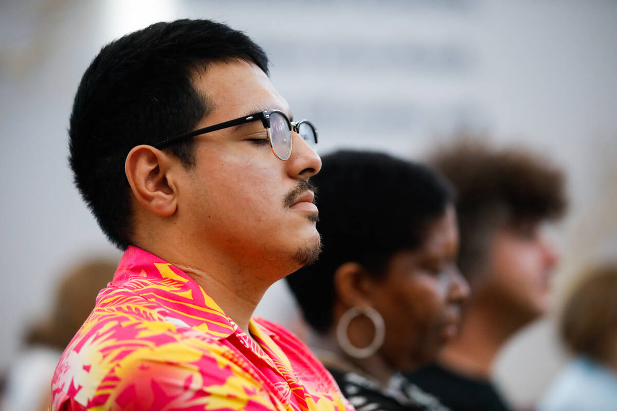 Robert Rodriguez closes his eyes during a prayer at a devotional for the Hawaiian fire victims ...