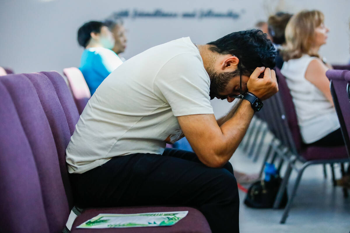 Kourosh Yazdani lowers his head in grief during a devotional for the Hawaiian fire victims held ...